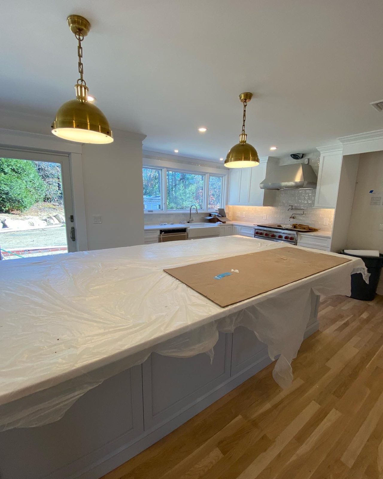 Kitchen with brass pendants and recessed lights